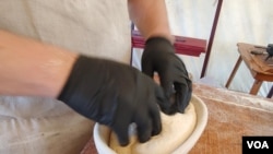 Chef Justin Cherry mixes, kneads, proofs and bakes the bread by hand, the way it would have been done during the Colonial period in U.S. history. (Deborah Block/VOA)