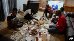 FILE - Mauritanians gather for a traditional meal, July 21, 2023, in Cincinnati.