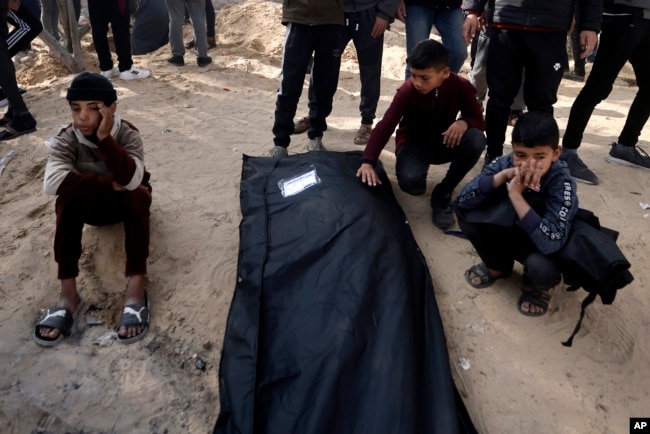 Palestinians mourn a relative killed in the Israeli bombardment of the Gaza Strip outside a morgue in Khan Younis, Jan. 22, 2024.