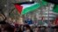 FILE - A child waves a Palestinian flag during a call for a cease-fire in Gaza, in Barcelona, Spain, Jan. 20, 2024. Spain is one of the countries that have officially recognized a Palestinian state. Armenia said Friday it also is recognizing a Palestinian state.