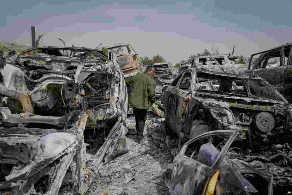 A Palestinian man walks between burned cars in a scrapyard, in the town of Hawara, near the West Bank city of Nablus.&nbsp;Many Israeli settlers went on a violent rampage in the northern West Bank, setting cars and homes on fire after two settlers were killed by a Palestinian gunman.&nbsp;