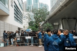 Members of the media wait outside the West Kowloon Magistrates' Courts during the national security trial of media mogul Jimmy Lai, founder of Apple Daily, in Hong Kong, China, Dec. 18, 2023.