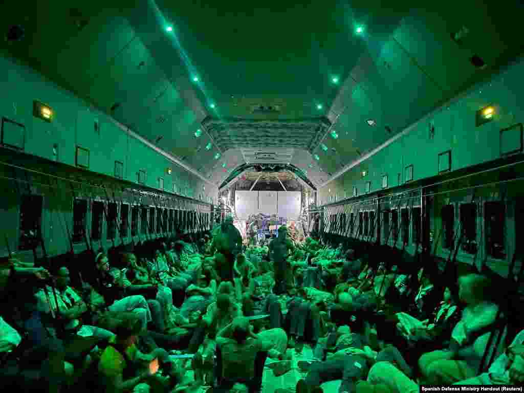 Spanish diplomatic personnel and citizens wait to disembark a military plane in Djibouti after they were evacuated from Sudan.