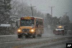 Cars move slowly on a ice-covered road in Wheeling, Illinois, Jan. 9, 2024.