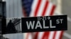 FILE - A sign for Wall Street outside the New York Stock Exchange in Manhattan in New York City, New York, Oct. 26, 2020. 