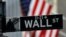 FILE - A sign for Wall Street outside the New York Stock Exchange in Manhattan in New York City, New York, Oct. 26, 2020. 
