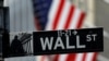 FILE - A sign for Wall Street outside the New York Stock Exchange in Manhattan in New York City, New York, Oct. 26, 2020. 