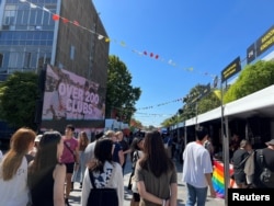 Students walk past stalls during the orientation week at The University of Sydney, in Camperdown, Australia February 15, 2023. (REUTERS/ Stella Qiu)