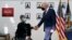 FILE - President Joe Biden shakes hands with veteran John Caruso at Fort Worth VA Clinic in Fort Worth, Texas, March 8, 2022. Biden on Aug. 10, 2022, signed veterans health care legislation that ended a long battle to expand benefits for people who served near burn pits.