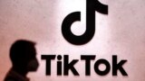 FILE - A visitor passes the TikTok exhibition stands at the Gamescom computer gaming fair in Cologne, Germany, Aug. 25, 2022. 