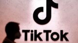 FILE - A visitor passes the TikTok exhibition stands at the Gamescom computer gaming fair in Cologne, Germany, Aug. 25, 2022. 