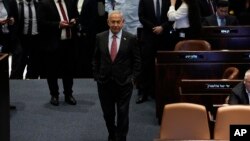 Israeli Prime Minister Benjamin Netanyahu on the floor the Knesset, Israel's parliament, as his coalition pressed ahead with a contentious plan to overhaul the country's judicial system, in Jerusalem, March 13, 2023. 