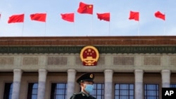 FILE - A Chinese soldier stands guard outside the Great Hall of the People after the opening ceremony of The Third Belt and Road Forum in Beijing, Oct. 18, 2023.