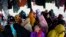 Ethnic Rohingya women take shelter under a tent near a beach where they landed on Dec. 10 in Pidie, Aceh province, Indonesia, Dec. 16, 2023. Since November, more than 1,500 Rohingya refugees fleeing Bangladesh by boat have landed in Indonesia’s northern province of Aceh.