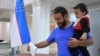 A voter in Uzbekistan casts a ballot in a referendum on a revised constitution, Tashkent, Uzbekistan, April 30, 2023. 