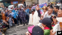 Veteran Sherpa guide Kami Rita, center, arrives at the airport in Kathmandu, Nepal, May 25, 2023, after scaling Mount Everest for the 28th time. 