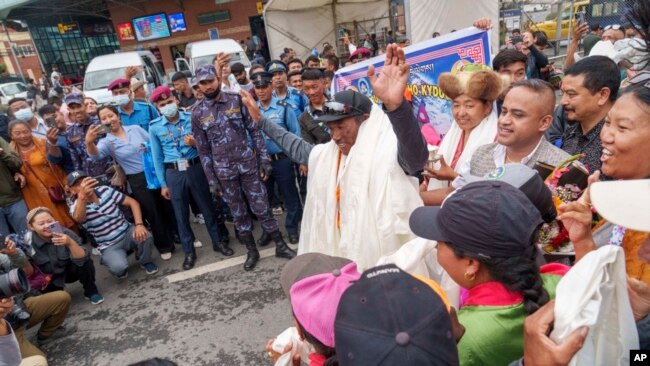 Veteran Sherpa guide Kami Rita, center, arrives at the airport in Kathmandu, Nepal, May 25, 2023, after scaling Mount Everest for the 28th time.