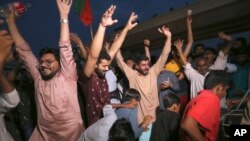 Supporters of Pakistan's former Prime Minister Imran Khan celebrate in Multan, Pakistan, May 11, 2023, after the Supreme Court's decision to release Khan, whose arrest sparked a wave of violence across the country by his supporters. (AP Photo/Asim Tanveer)