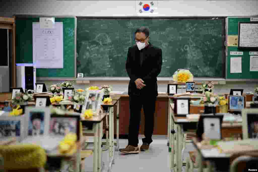 A man takes a look around a replicated classroom of students who died in the sunken Sewol ferry disaster that killed 304 people, mostly school students, in Ansan, South Korea.