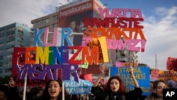 FILE - Women chant slogans during a rally marking the International Day for the Elimination of Violence Against Women, in Istanbul, Nov. 25, 2023.