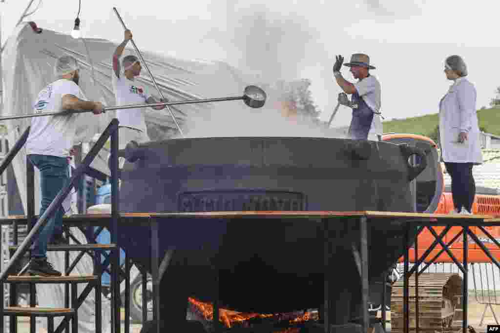 Chefs prepare a broth with over 700kg of tilapia during the Tilapia Regional Festival in Armazem, Brazil, April 28, 2024.