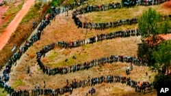 FILE—People queue to cast their votes In Soweto, South Africa April 27, 1994, in the country's first all-race elections. 