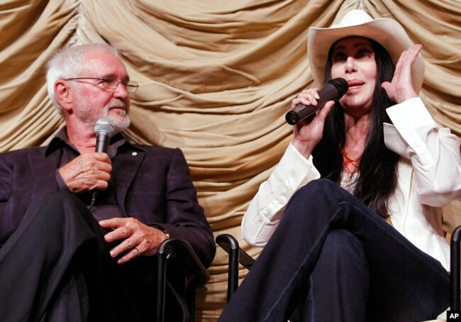 FILE - Actress and singer Cher, right, speaks to an audience as director Norman Jewison looks on at a tribute event and screening for Jewison at the Los Angeles County Museum of Art in Los Angeles, April 17, 2009.