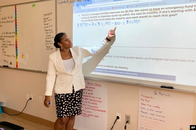 Tonica Tatum-Gormes leads her students through a math problem involving a money-saving strategy at Capital City Public Charter School in Washington on Sept. 12, 2023. (Jackie Valley/The Christian Science Monitor via AP)