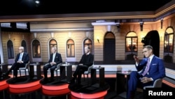 Presidential candidates Olli Rehn, Pekka Haavisto, Jussi Halla-aho and Alexander Stubb sit in the MTV studio before the presidential elections debate in Helsinki, Finland, Jan. 24, 2024. (Lehtikuva/via Reuters)
