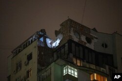 Damages are seen on the rooftop of a residential building after a Russian attack in Kyiv, Ukraine, Dec. 22, 2023.