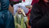 A woman shouts as she attends a protest in front of the state-run TV headquarters in Belgrade, Serbia, May 27, 2023.