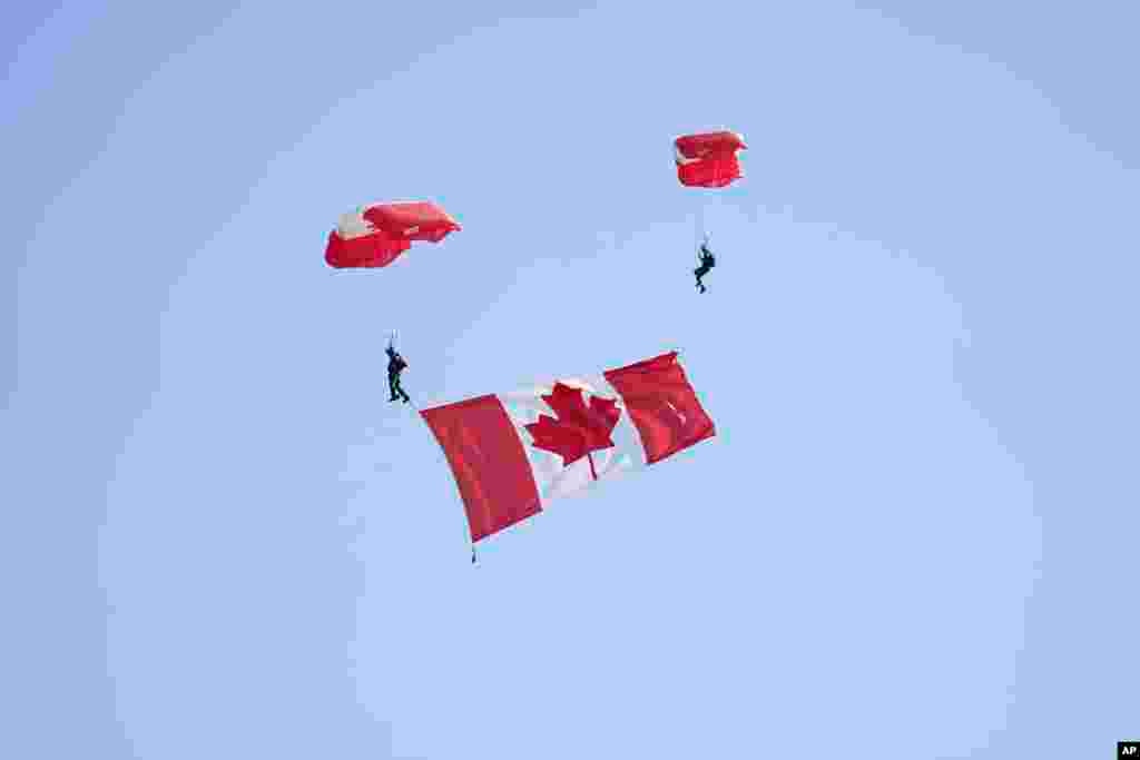 Parachuters drop over the event ahead of the Government of Canada ceremony to mark the 80th anniversary of D-Day, at Juno Beach in Courseulles-sur-Mer, Normandy, France, June 6, 2024.&nbsp;