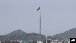 FILE - A North Korean flag flutters in the wind atop a tower in the North's Kijong-dong village near the truce village of Panmunjom in the Demilitarized Zone in Paju, South Korea, on Sept, 28, 2017. 