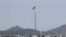FILE - A North Korean flag flutters in the wind atop a tower in the North's Kijong-dong village near the truce village of Panmunjom in the Demilitarized Zone in Paju, South Korea, on Sept, 28, 2017. 