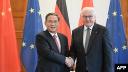 German President Frank-Walter Steinmeier, right, and Chinese Premier Li Qiang shake hands on June 19, 2023 at the presidential Bellevue Palace in Berlin.