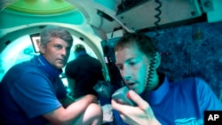 FILE - Pilot Randy Holt, right, and Stockton Rush, CEO of OceanGate, dive in the company's Antipodes submersible off Fort Lauderdale, Fla., June 28, 2013. Rush and four others died in a submersible implosion, the U.S. Coast Guard said June 22, 2023.
