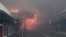 Smoke and flames from wildfires fill the air on Front Street in downtown Lahaina, on the island of Maui in the state of Hawaii, Aug. 8, 2023. Maui officials say the fire has destroyed dozens of homes and businesses in the historic town of Lahaina. (Alan Dickar via AP)