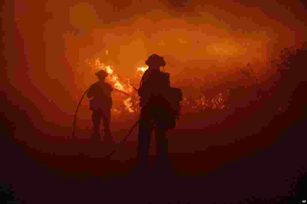 Firefighters work against the advancing Post Fire in Gorman, California.