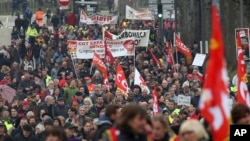 Unions and people demonstrate in Bayonne, southwestern France, March 7, 2023. Garbage collectors, utility workers and train drivers are among people walking off the job across France to show their anger at a bill raising the retirement age to 64.