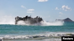 A Japan Maritime Self Defense Force landing craft air cushion prepares to land on Bellows Beach during a joint exercise between Japan and the Peruvian navy at the Rim of the Pacific (RIMPAC) military exercises in Waimanalo, Hawaii, July 18, 2024.