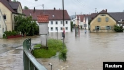 A street is flooded by the river Schmutter, following heavy rainfalls in Fischach, near Augsburg, Germany, June 1, 2024.