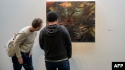 People look at Julie Mehretu's 'New Dawn, Sing (for Nina)' displayed as part of the Nina Simone Childhood Home Auction Exhibition, at the Pace Gallery in New York on May 19, 2023.