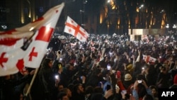 Georgian opposition supporters rally calling for government to follow 'pro-Western' path, outside the parliament in Tbilisi on March 9, 2023.