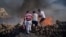 FILE - Local residents try to extinguish a fire, near the seaside resort of Lindos, on the Aegean Sea island of Rhodes, southeastern Greece, on July 24, 2023.