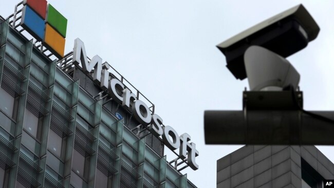 FILE - A security surveillance camera is seen near the Microsoft office building in Beijing, July 20, 2021.