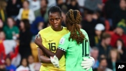 Nigeria's goalkeeper Chiamaka Nnadozie, left, and Nigeria's Christy Ucheibe hug during a penalty shootout during the Women's World Cup round of 16 soccer match between England and Nigeria in Brisbane, Aug. 7, 2023.