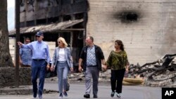 President Joe Biden and first lady Jill Biden walk with Hawaii Gov. Josh Green and his wife Jaime Green as they visit areas devastated by the Maui wildfires, in Lahaina, Hawaii, Aug. 21, 2023.