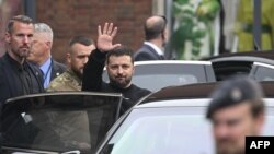 Ukraine's President Volodymyr Zelenskyy waves as he wraps up his trip to Germany before heading to France, in Aachen, Germany, May 14, 2023.