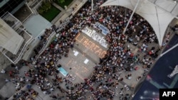 People surround lit candles forming the words "Freedom and Peace" during a vigil demanding freedom for political prisoners arrested during protest following the contested re-election of Venezuelan President Nicolas Maduro in Caracas, Aug. 8, 2024.