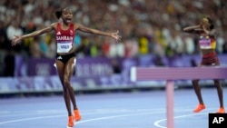 Winfred Yavi of Bahrain celebrates winning the gold medal in the women's 3,000 steeplechase at the 2024 Summer Olympics, Aug. 6, 2024, in Paris. Yavi is Kenyan but has competed for Bahrain since 2014. 